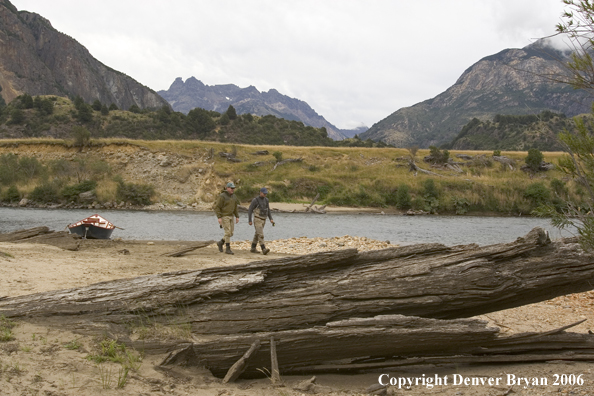 Flyfishermen walking up river.