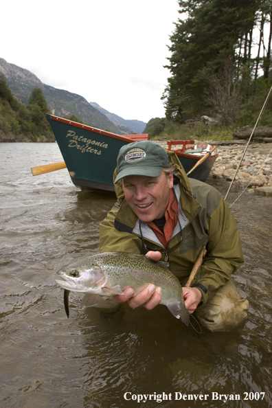 Flyfisherman holding nice rainbow trout.