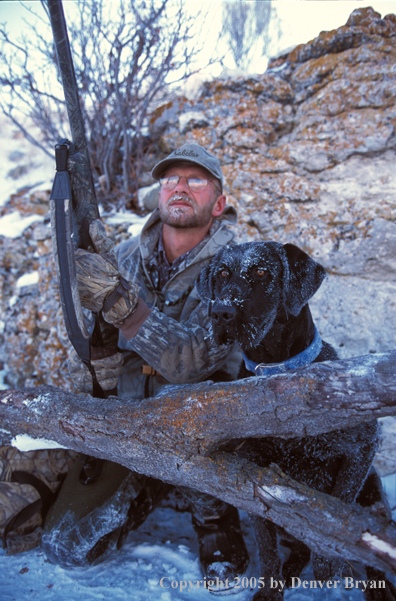 Waterfowl hunter with black Lab. 