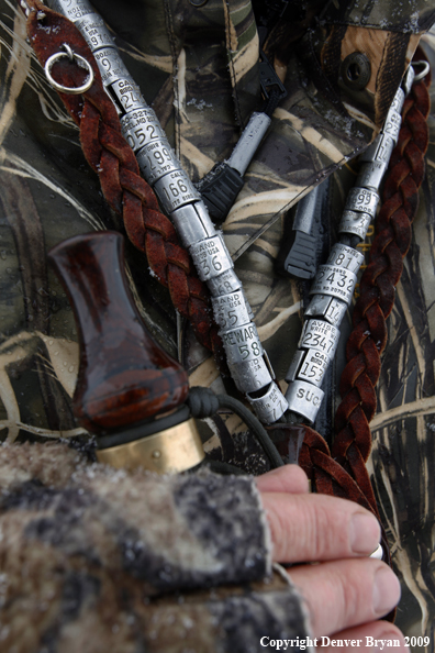 Waterfowl hunter with duck call and bands.