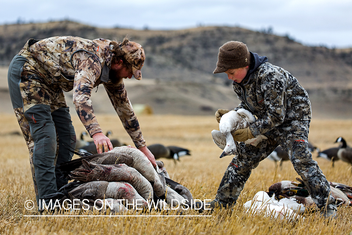 Father and son with bagged waterfowl.