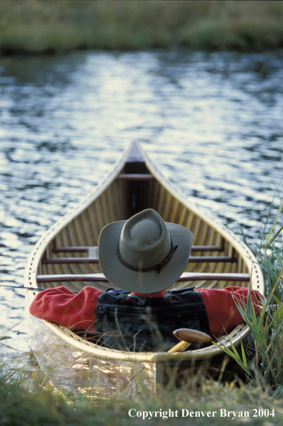 Flyfisherman in wooden cedar canoe.  