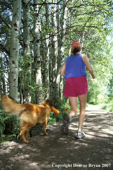 Woman running with golden Retriever