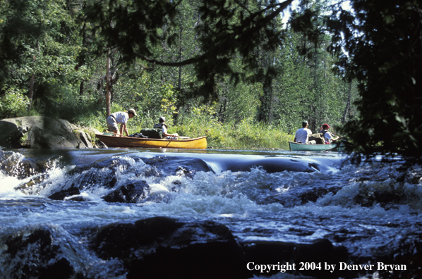 Father and son in cedar canoe.