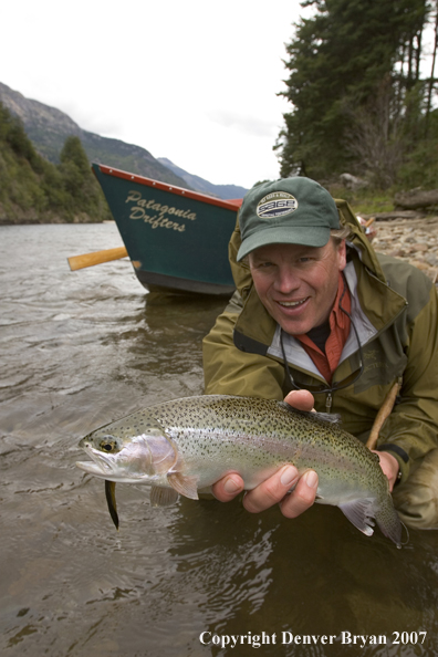 Flyfisherman holding nice rainbow trout.