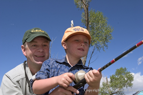 Father helping son spincast fishing