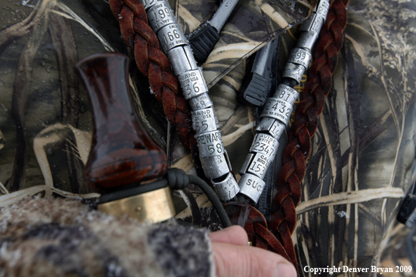 Waterfowl hunter with duck call and bands.