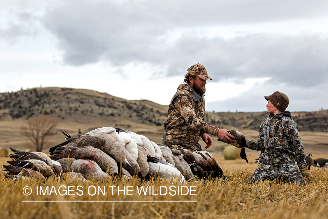 Father and son with bagged waterfowl.