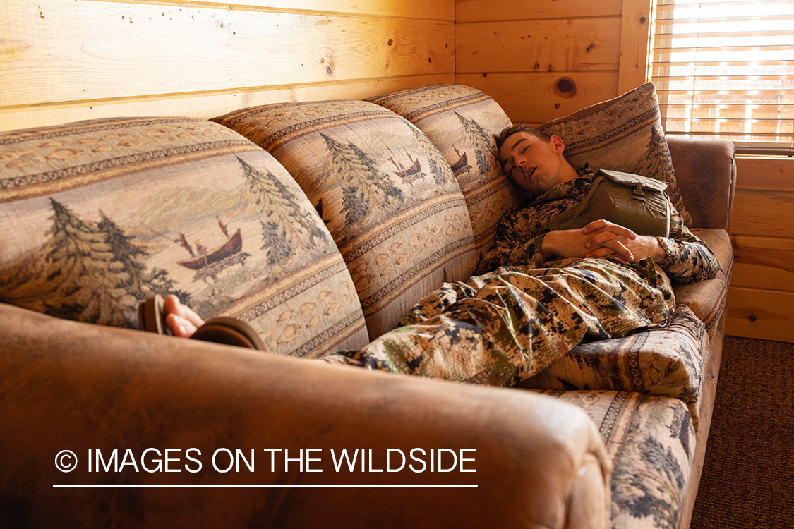 Turkey hunter asleep in cabin.