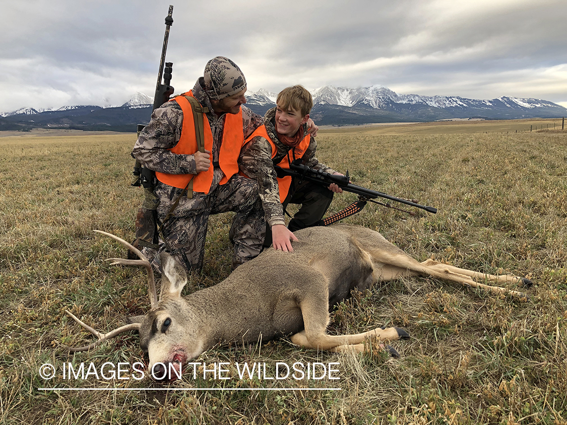 Father and son with downed mule deer.