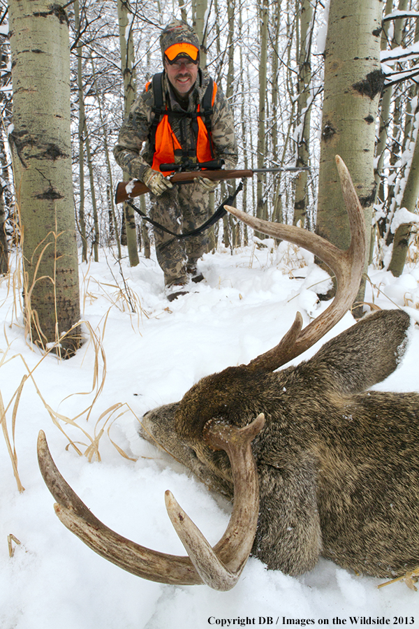 Hunter with bagged white-tailed deer.