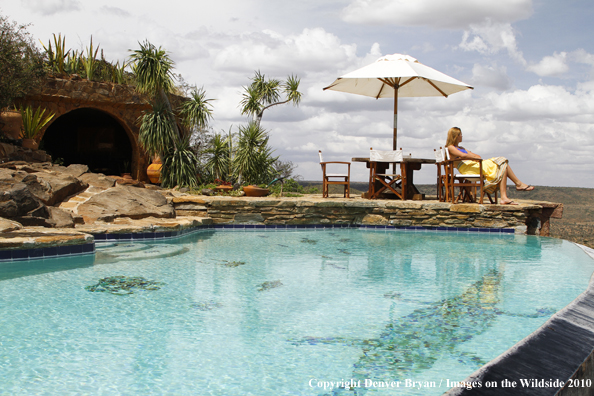 Woman by infinity pool