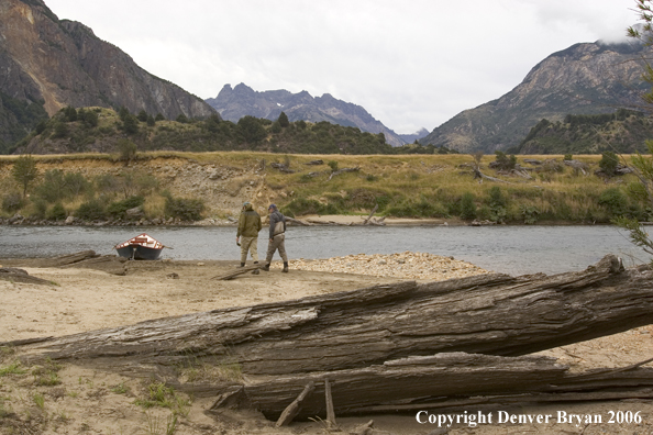 Flyfishermen walking to driftboat.