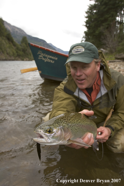 Flyfisherman holding nice rainbow trout.