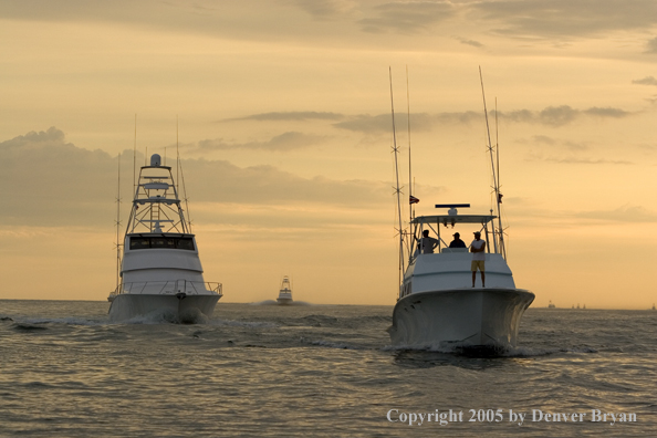 Deep sea fishing charter boats on ocean.