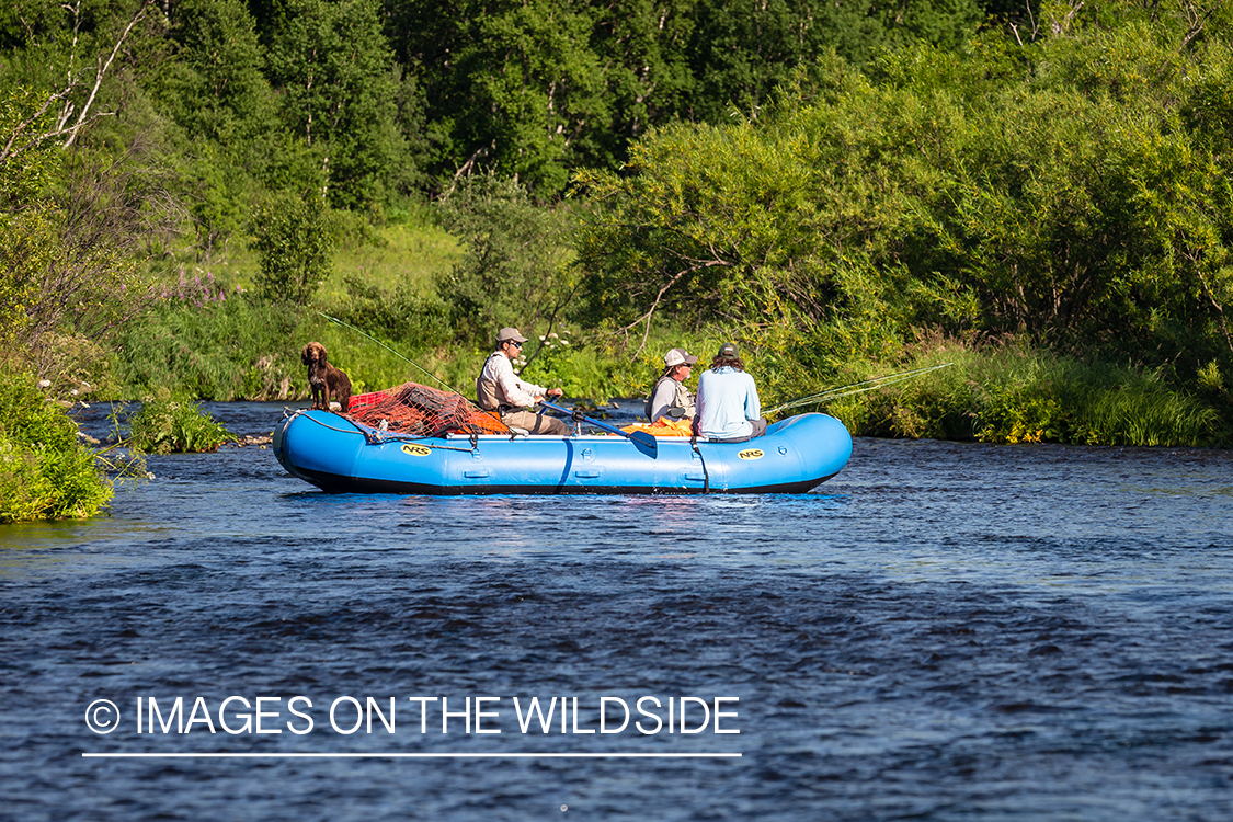 Flyfishermen on raft in Sedanka river in Kamchatka Peninsula, Russia.