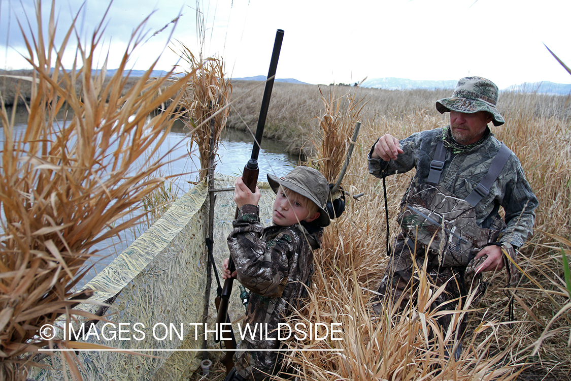 Father and son waterfowl hunting.