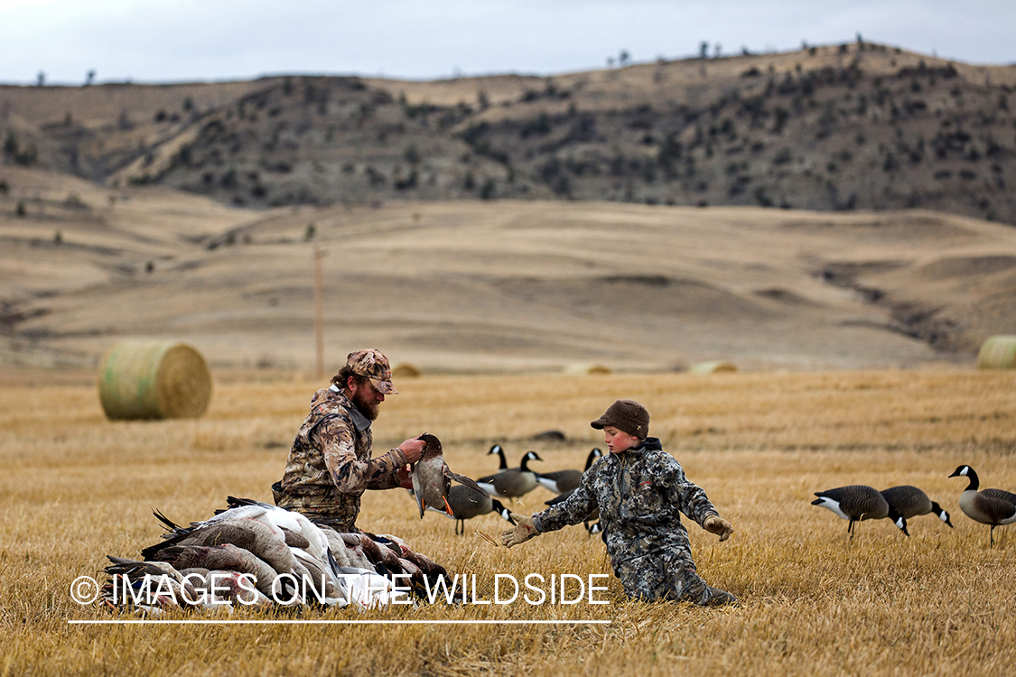 Father and son with bagged waterfowl.