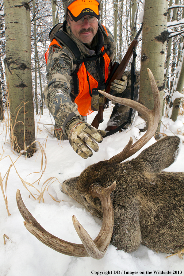 Hunter with bagged white-tailed deer.