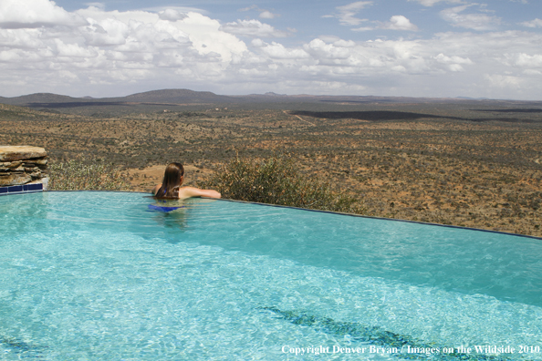 Woman by infinity pool