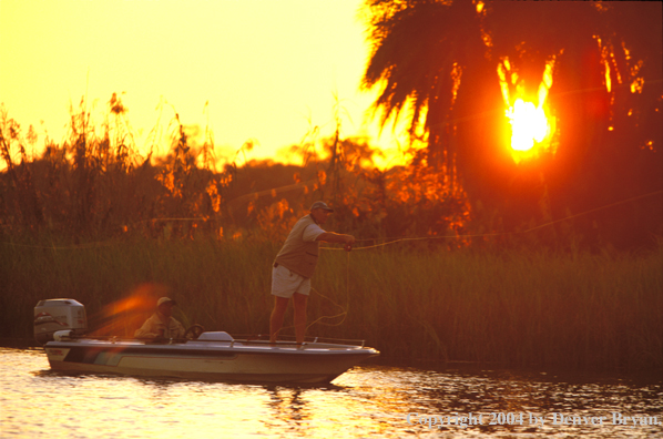 Flyfisherman casting from boat.