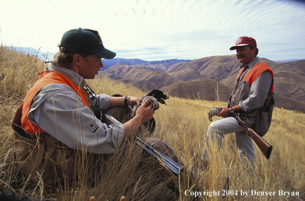 Upland bird hunters with bagged chukars.