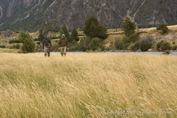 Flyfishermen walking from river.  