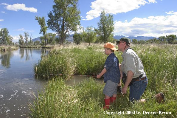 Father helping son spincast fishing