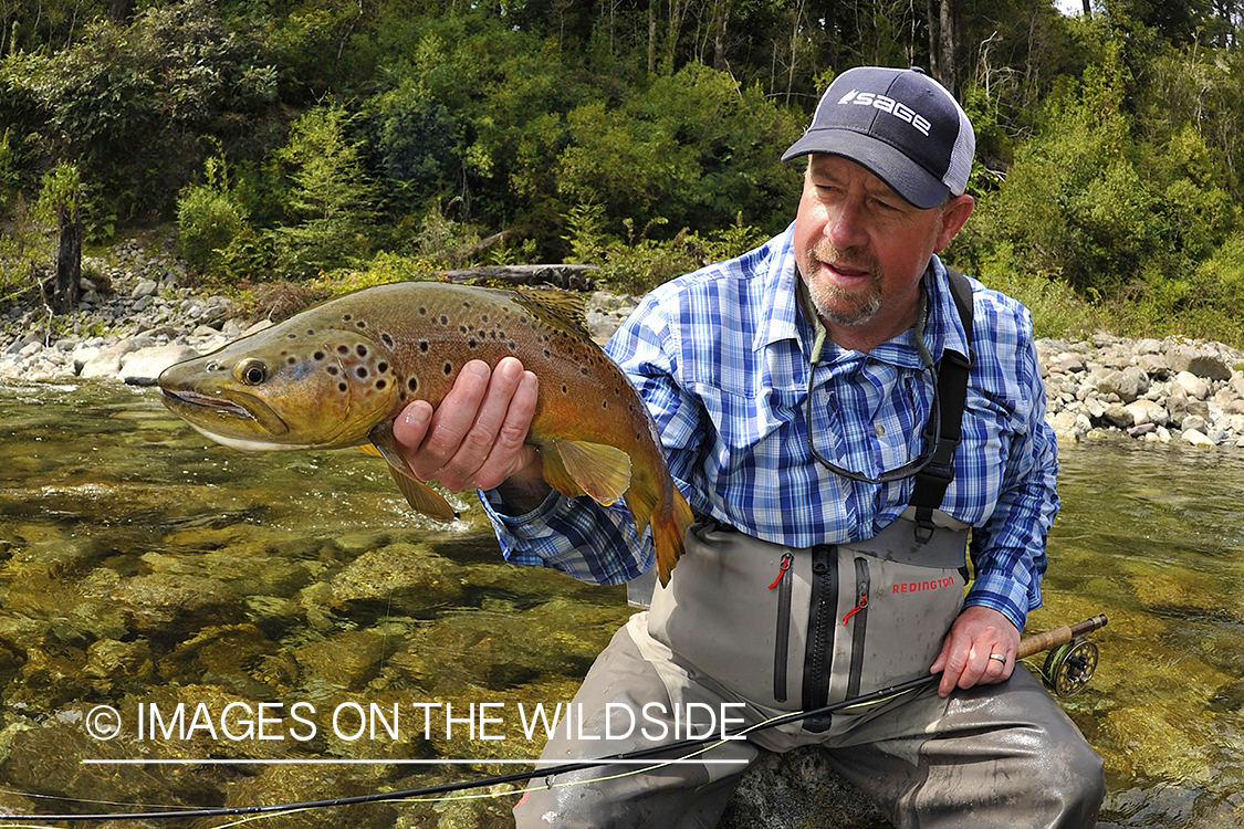 Fisherman with brown trout.