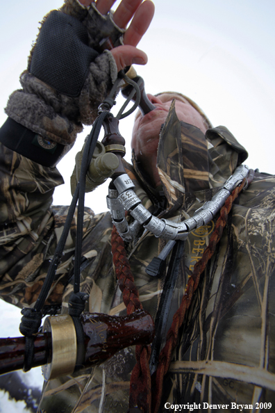 Waterfowl hunter with duck call.