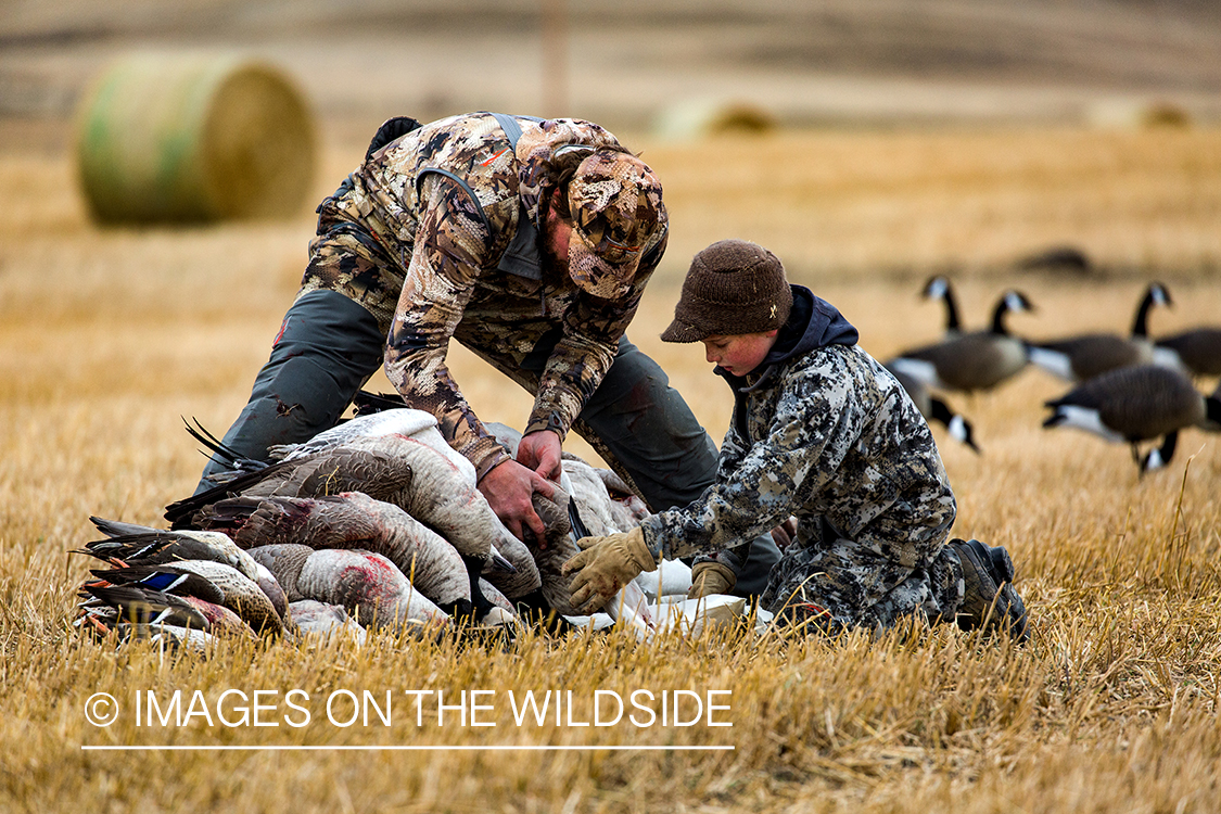 Father and son with bagged waterfowl.