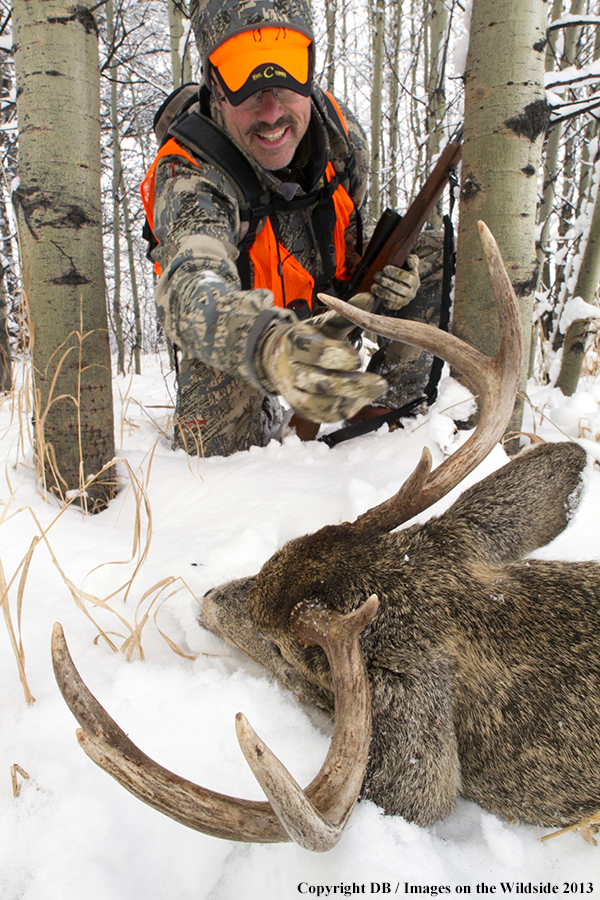 Hunter with bagged white-tailed deer.