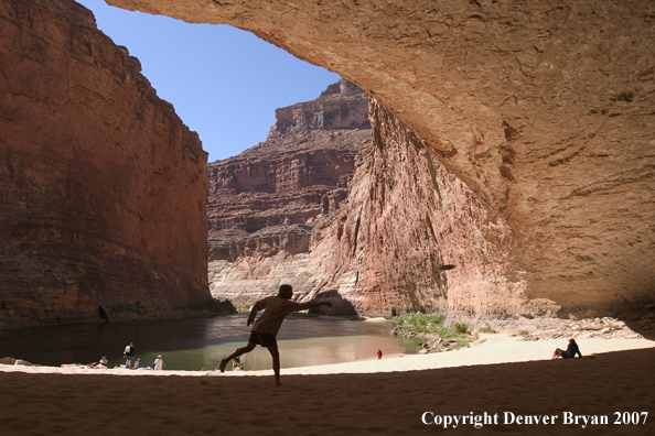 Hikers playing and exploring along the Colorado River.  Grand Canyon.