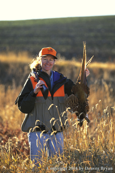 Upland game bird hunter with bagged pheasant.