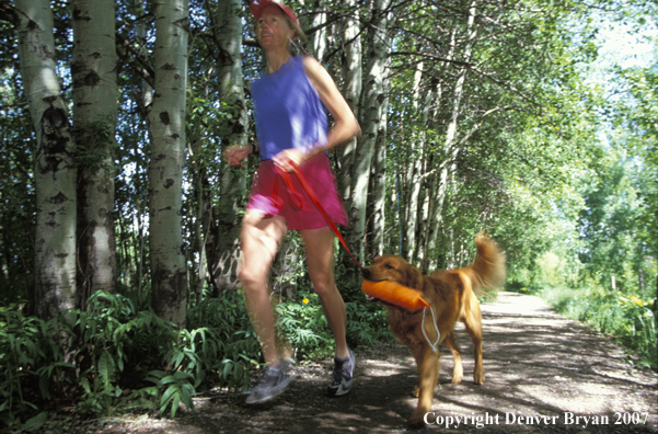 Woman running with golden Retriever