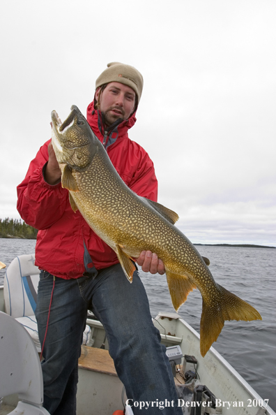 Fisherman with lake trout (MR).