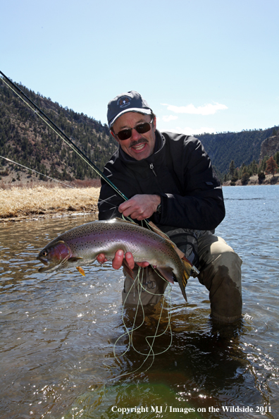 Flyfisherman with nice rainbow trout.