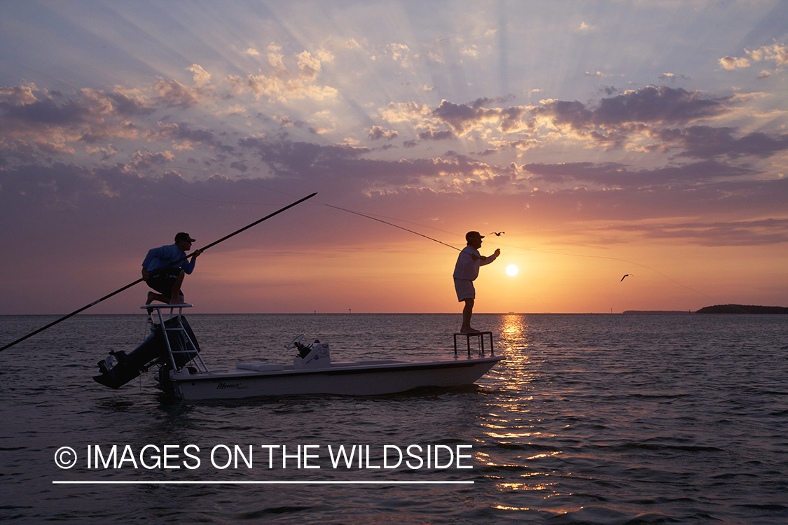 Flyfisherman casting from boat during sunset.