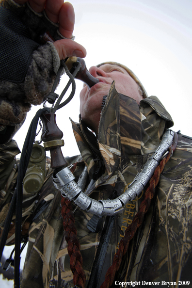 Waterfowl hunter with duck call.