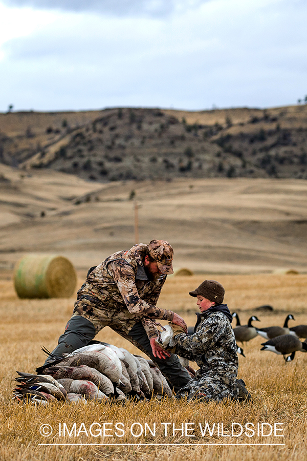 Father and son with bagged waterfowl.