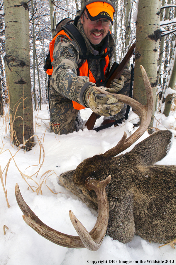 Hunter with bagged white-tailed deer.