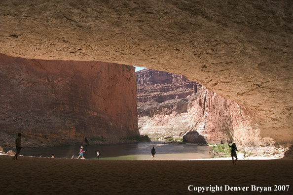 Hikers playing/exploring along side the Colorado River.  Grand Canyon.