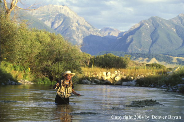 Woman flyfisher fishing river.