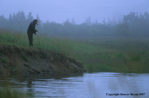 Flyfisherman in fog fishing