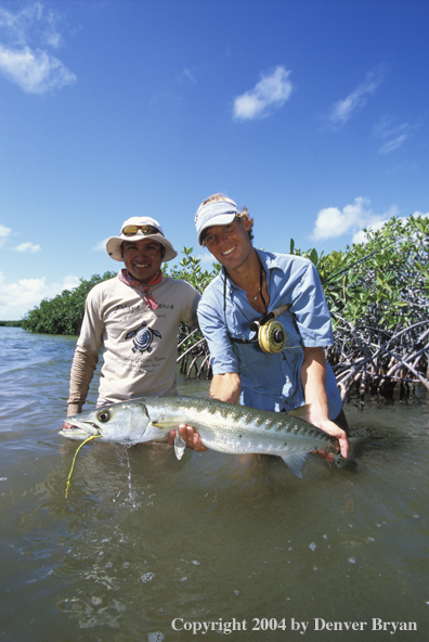 Saltwater flyfisherman and guide releasing barricuda.