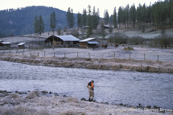 Flyfisherman tying on a fly.