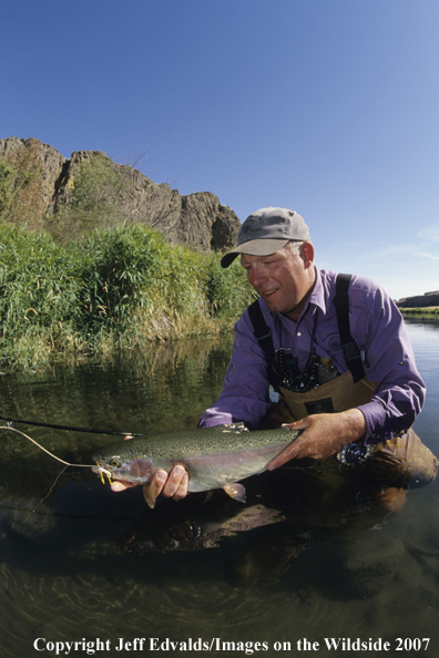 Angler with nice Rainbow Trout