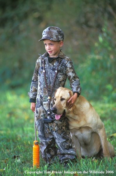 Yellow Labrador Retriever with young boy.