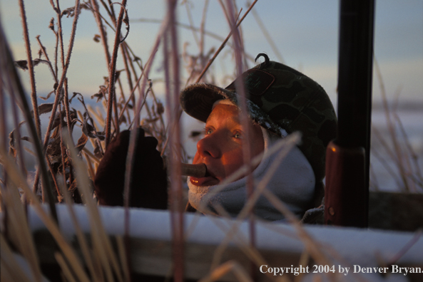 Waterfowl hunter calling birds.