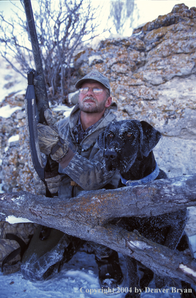 Waterfowl hunter with black Lab. 